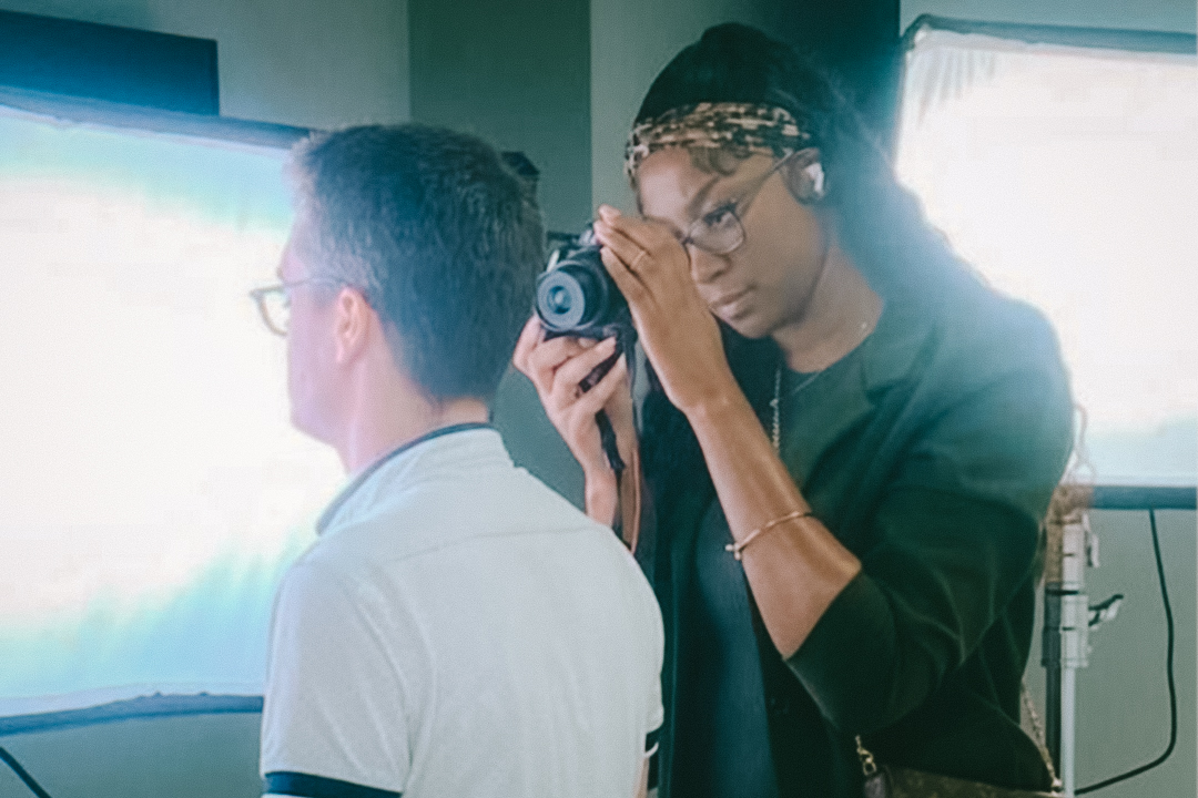 A photographer takes a picture of a tester wearing a hearing aid.